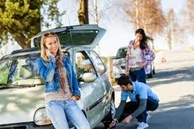 Man Changing Tire for Woman