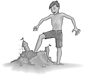 boy kicking sand castle